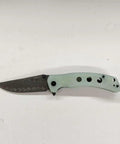 Damascus Pocket Folding Knife With 3.26 Inch Sharp Blade And G10 Handle, side view on white background.