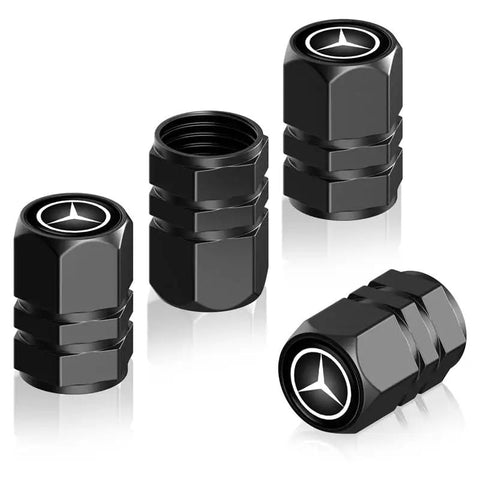 Four black Mercedes Benz tire valve caps featuring logo, part of the Mercedes Benz Tire Valve Caps And Leather Keychain Set.