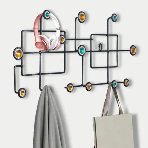 Rock Solid Wall Mounted Coat Rack With Sleek Iron Design Multi Hook Organizer for jackets, hats, and headphones on wall.