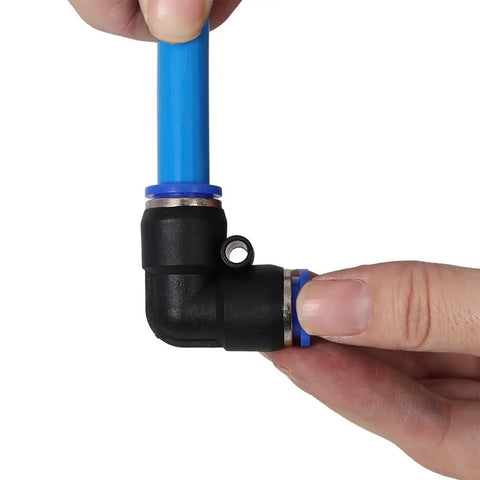 Badass 60 Foot PU Air Hose Line Kit With Push To Connect Fittings Dope Flexibility For Garage Shops And Tight Spaces Killer For Air Tools Pneumatic Nail Guns Real Deal Toughness In Cool Blue Color Gets The Grind Done. Blue PU air hose push-to-connect elbow fitting held by hand