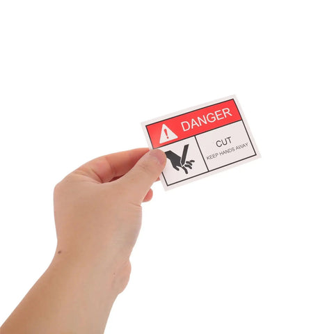 Hand holding 5 Pack Machinery Safety Stickers Keep Hands Away Hazard Decal For Moving Parts And Equipment Warning Sign In The Workplace