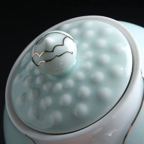 Close-up of the lid knob of Airtight Ceramic Coffee Canister Porcelain Tea Caddy With Tight Seal Lid Keeps Your Stash Fresh As A Dime For Kitchen Pantry Organization Blue Jar.