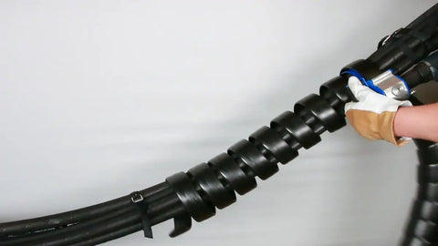 Person installing Go-To Safe-Spiral Pre-Cut Spiral Wrap For Hoses And Cables Black HD-PE 0.50 Inch OD By 25 Foot Pre-Cut Length on cables