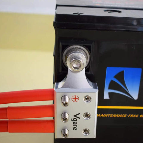 Top Shelf Heavy Duty Battery Terminal Clamps For Lithium Or Agm Lead Acid Batteries Featuring Bolt Down Ends And Threaded Studs Matching M8 Or Common 5 16 Inch Threads For Fast Hookup, mounted on a battery with red cables.