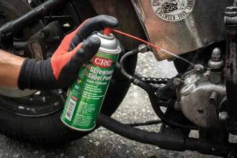 Person using Super Penetrant Aerosol For Corroded Fasteners And Seized Mechanical Components Plastic Safe Formula Fast Acting Rust Release