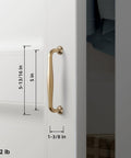 Side view of Six Pack 5 Inch Center To Center Modern Champagne Bronze Cabinet Pulls with sleek tapered handles on a white cabinet.