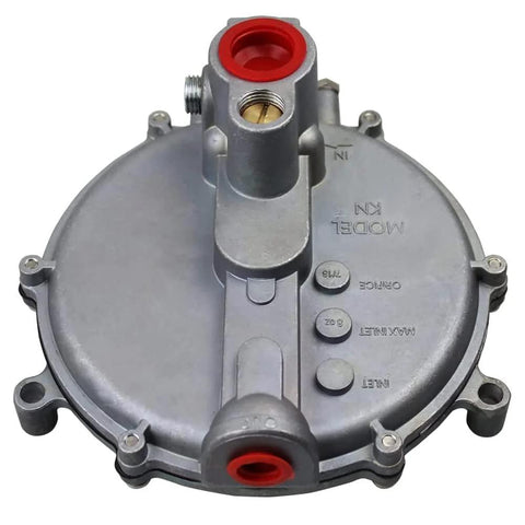 Front view of gray metal low-pressure natural gas regulator with red inlet/outlet ports