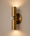 Modern Brass Wall Sconce – Mid Century Cylinder Up and Down Wall Light, minimalist design with brushed brass finish, mounted on wall.