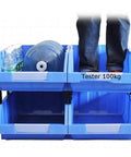 Hella Rugged Wall Mounted Storage Rack Featuring Thirty Bright Plastic Bins For Garage Tool Sorting Screws Nuts Bolts Small Hardware Parts Fast Assembly No Sweat Organization Daily with blue bins and person standing on top.