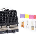 Commercial 1800W Bubble Skewer Waffle Ball Machine with dual heating plates and utensils for snack preparation.