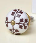 Kick Your Cabinet Updates To The Next Level With One Hundred Brown Ceramic Drawer Knobs Featuring Detailed Leaf And Blossom Accents For Kitchen Cabinets And Dressers Plus Rust Free Hardware. Close-up of brown ceramic drawer knob with floral design.