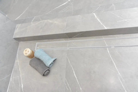 High Grade 304 Stainless Steel Linear Shower Drain 60 Inch Matte White Tile In Bathroom Floor Grate with rolled towels.