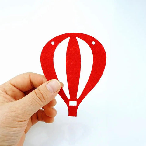 Hand holding red felt hot air balloon piece from Colorful Felt Hot Air Balloon Garland Two Pack Banner Easy To Set Up For Birthday Party Sky Theme Wall Decor With 20 Colorful Balloons Included Ropes And Plastic Needles.