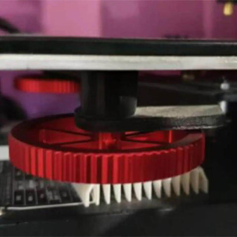 Close-up of 3D printer with red gear and 12Pcs Silicone Bed Spacers And Mounts For 3D Printers Easy Bed Leveling Kit installed.