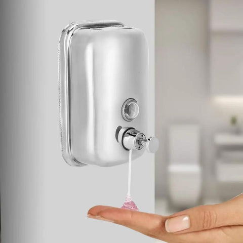 Heavy Duty Stainless Steel Wall Mount Soap Dispenser With Smooth Glide Manual Pump dispensing soap onto hand in bathroom.