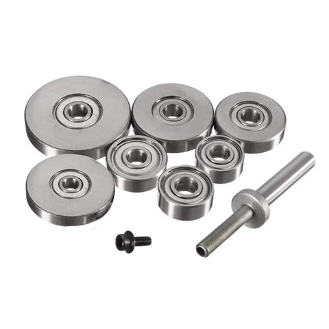 Seven Piece Top Mounted Bearing Replacement Kit For Rabbeting Router Bits With Ball Bearing Guides arranged on a white surface