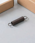 Heavy Duty Two Pack Hook Extension Springs For Recliner Chair Repair Solid Black Steel DIY Furniture Fix on grey surface.