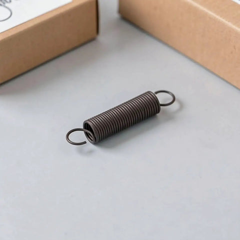 Heavy Duty Two Pack Hook Extension Springs For Recliner Chair Repair Solid Black Steel DIY Furniture Fix on grey surface.