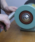 Person using Hella Durable 8 Inch Polyurethane Buffing Wheel on a metal piece for mirror polish.