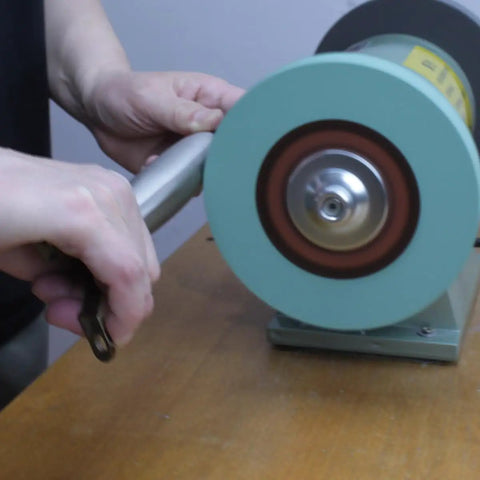 Person using Hella Durable 8 Inch Polyurethane Buffing Wheel on a metal piece for mirror polish.