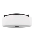 Sunset Drive Two Light Flush Mount Ceiling Light In Oil Rubbed Bronze for hallways, viewed from below showing white diffuser and bronze trim.