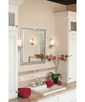 Bathroom setting with Hendrik 12 Inch Wall Sconce In Brushed Nickel With Satin Etched Cased Opal Glass flanking a mirror.