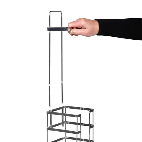 Hand holding top handle of Go To Vertical Free Standing Chrome Toilet Paper Holder Dispenser with Four Roll Capacity.