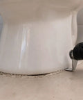 10 Pack 1 Inch Stainless Steel Serrated Caulking Scrapers in action on bathroom sealant, tool removing caulk efficiently
