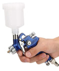 Top Tier Hvlp Gravity Feed Spray Gun Precision Zero Point Eight Millimeter Tip Tough Aluminum Body held in hand with gravity cup.