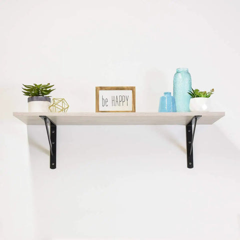 Beefy Heavy Duty Shelf Brackets Set 10 Pack Black Powder Coat Steel 10 By 16 Inches Pre Drilled One Quarter Inch Holes On Each Side Fits Sixteen Inch Stud Centers Up To One Thousand Lbs Per Pair Capacity For Garage Or Workshop Shelves supporting a decorative shelf with plants and a sign.