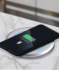 Top Shelf Retractable Countertop Power Outlet With Easy Peasy Automatic Lift And Fast Usb Charging Ports Round Pop Up Electrical Box on marble surface with smartphone charging.
