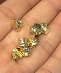 Polished Gold Grip Screws Set For Taurus Pt92 Pt96 Pt57 Pt58 Firearms held in a hand, showcasing four fat and one slim gold screws.