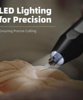 Close-up of cordless ultrasonic craft cutter kit for DIY projects multi material cutter with LED lighting in use