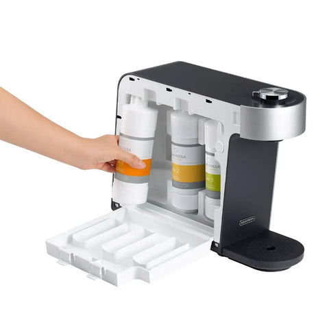 Hand inserting filter in Aquamega 100 Countertop Water Purifier With Three Stage Filtration and Direct Flow Technology, black silver finish