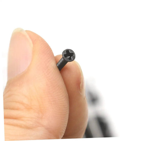 Heavy Duty Small Screw Assortment Kit Featuring 18 Miniature Flat Head Machine Screws Forged From Solid Carbon Steel, showing a flat head screw held between fingers.