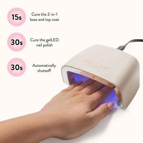 Hand under LED lamp curing nails, part of All In One Gel LED Nail Kit For Beginners With At Home Manicure Starter Set 32 Pieces