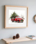 Watercolor Red Pickup Truck Wall Art Featuring a Christmas Tree in Tow for Cozy Farmhouse Holiday Decor Vibes displayed on wall.