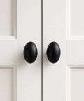 Oval Matte Black Cabinet Knobs 10 Pack For Kitchen And Furniture By EAXINTA Modern Single Hole Hardware Installed on White Cabinets
