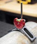 MPCH250 magnetic pipe centering head with red anodized 360° dial mounted on gray clamp around a metal pipe; bubble level visible.