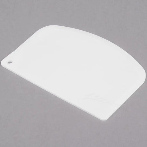 White flexible polypropylene bowl scraper on grey background. Two Flexible Polypropylene Bowl Scrapers That Help You Get Every Last Drop Of Dough Batter Or Icing From Mixing Bowls And Flat Surfaces And Conform To Curves For Mess Free Scraping.