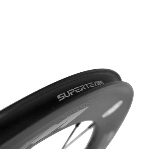 Close-up of Carbon Clincher Wheelset 700C Fixed Gear Wheels 60/88mm Depth With Basalt Braking Surface featuring Superteam branding.