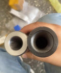 Front view of two metal Morse taper reducing sleeves (gray and black) with hollow bores