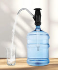 Swap Dead Electric Pumps For This Rugged Hand Operated Drum Pump Designed For Caravan And Rv Sinks delivering water flow into a glass.