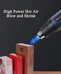 Adjustable hot air gun in use to shrink wrap retail packages, showcasing high power for efficient packing.