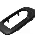 Black textured plastic tailgate handle bezel cover for 1999–2007 Silverado/Sierra; rear exterior, side view