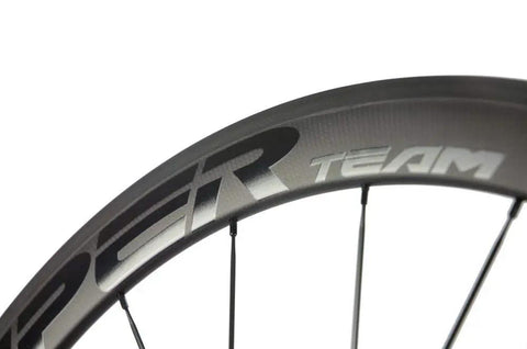 Beast 50mm Carbon Basalt Braking Surface Clincher Road Wheelset 700c with matte 3k finish detail view of rim with Team logo