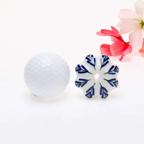 Snag These Six Piece Vintage Shabby Ceramic Cabinet Knobs With Hand Painted White And Blue Floral Drawer Pulls For Cupboard And Dresser Hardware To Level Up Your Home Decor Game Today, featuring a floral knob next to a golf ball.