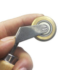 40mm seam roller with wooden handle and brass detail, used for roofing tape installation