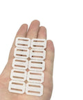 Hand displaying 40-Piece RC Airplane Hinge Set Folding Leaf Paper Hinges for aileron and tail wing connectors in white.
