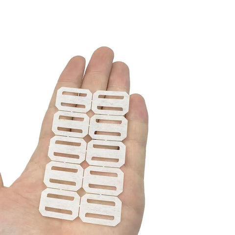 Hand displaying 40-Piece RC Airplane Hinge Set Folding Leaf Paper Hinges for aileron and tail wing connectors in white.